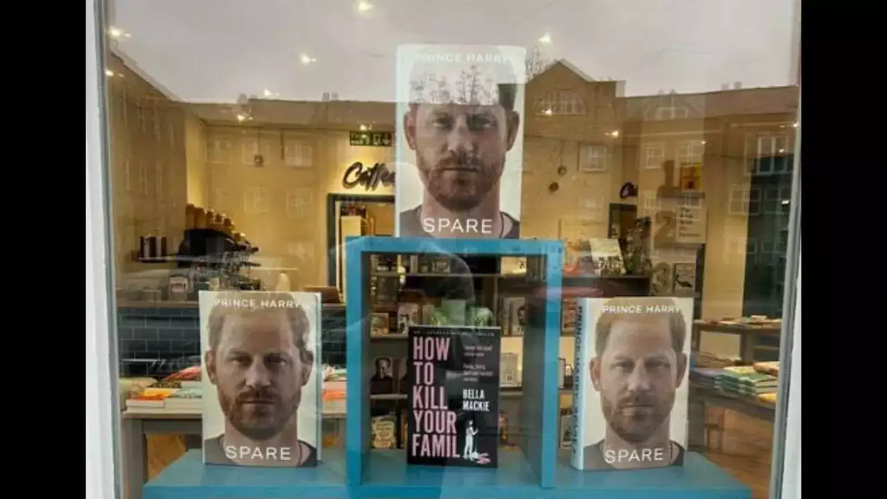 Book shop window featuring "Spare" and novel "How to kill your family"