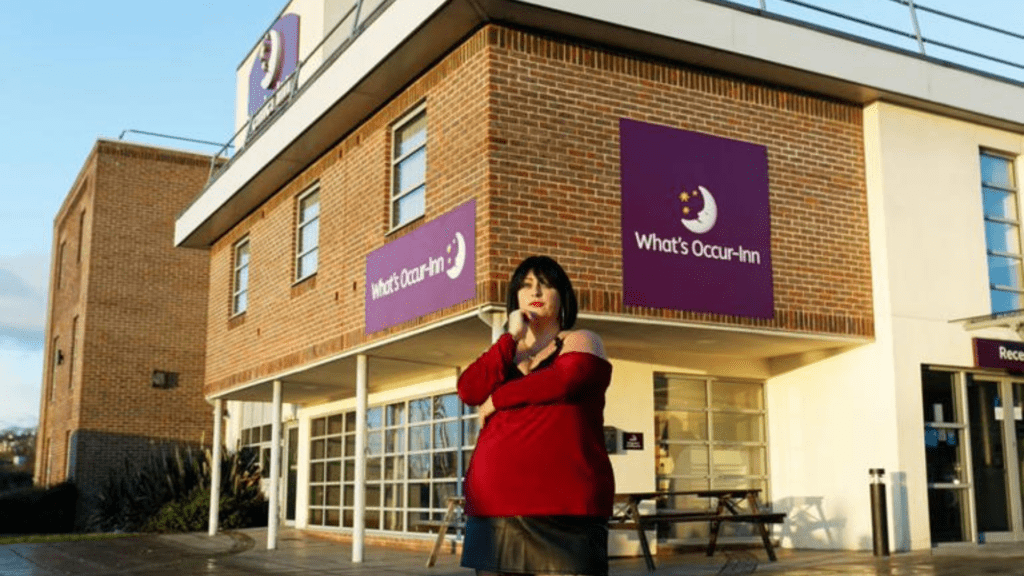 Actress Ruth Jones standing outside a Premier Inn hotel